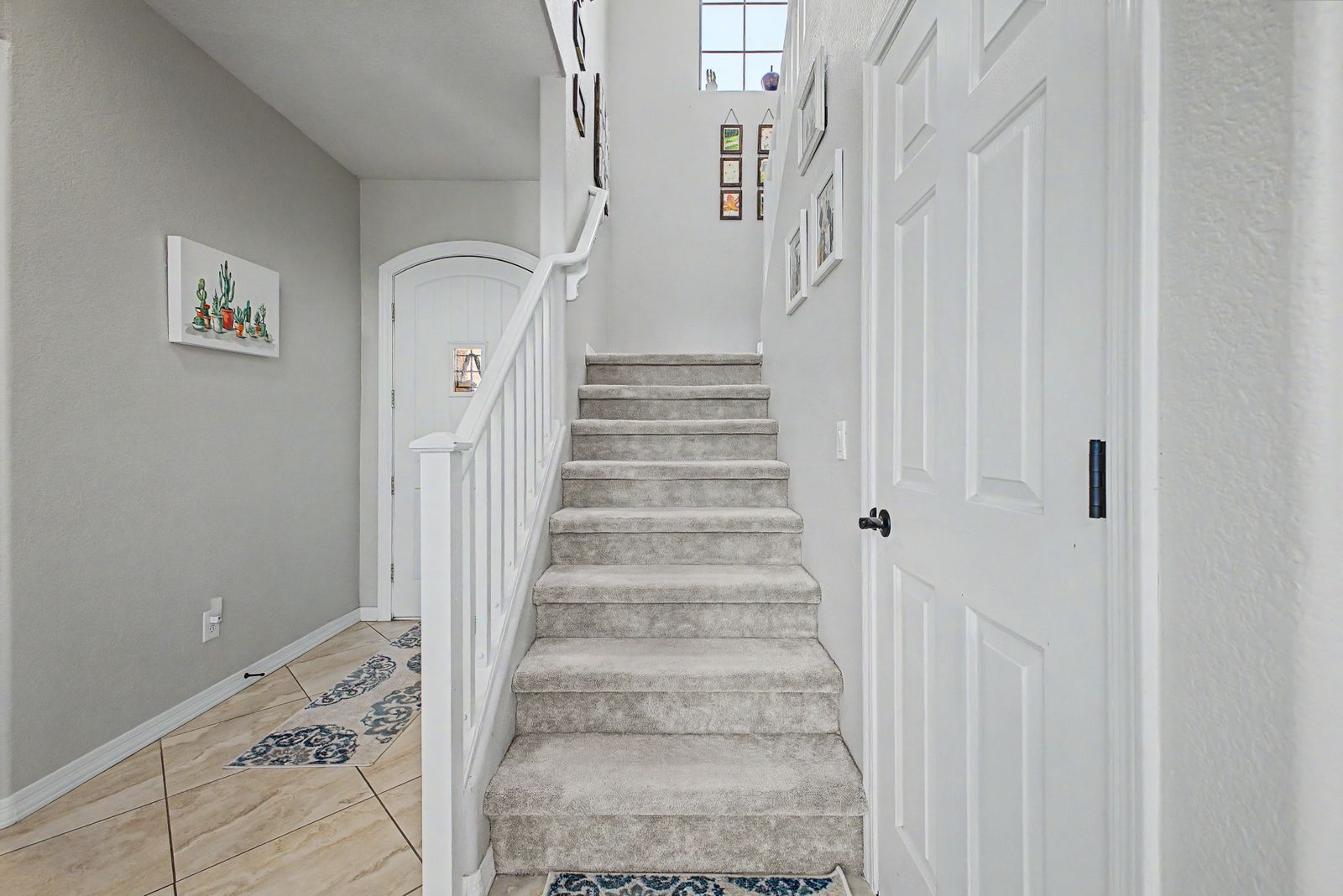 Carpeted staircase off the entry