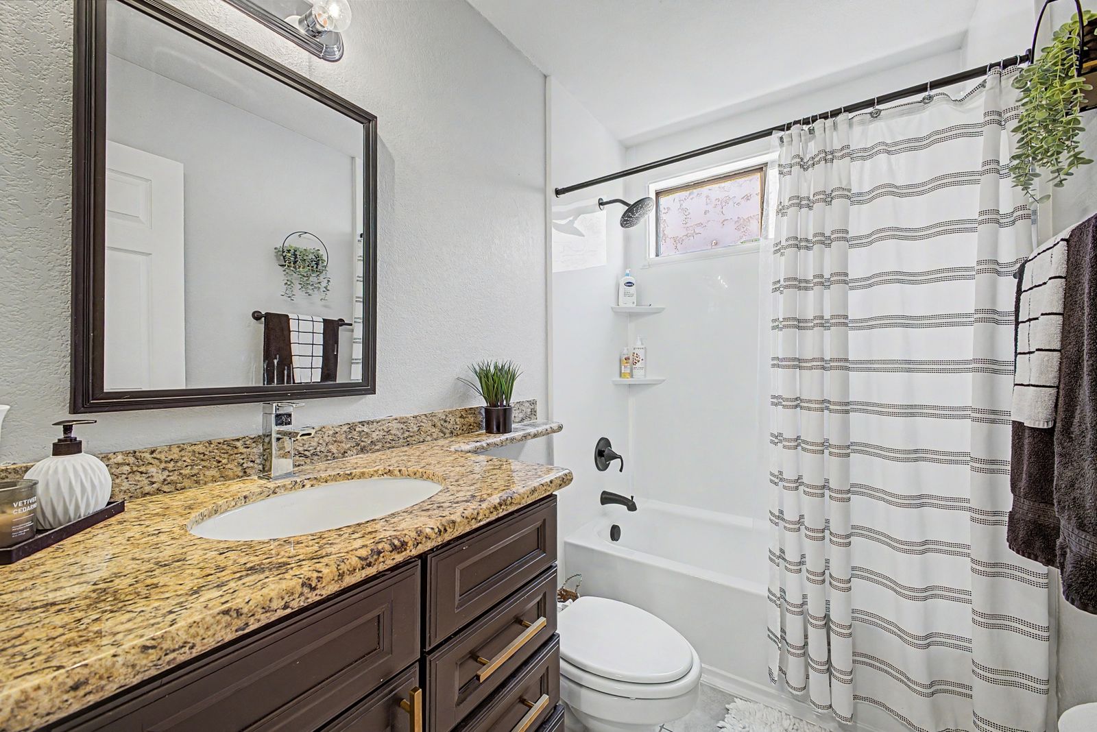 Hall bathroom with granite vanity and tub-shower