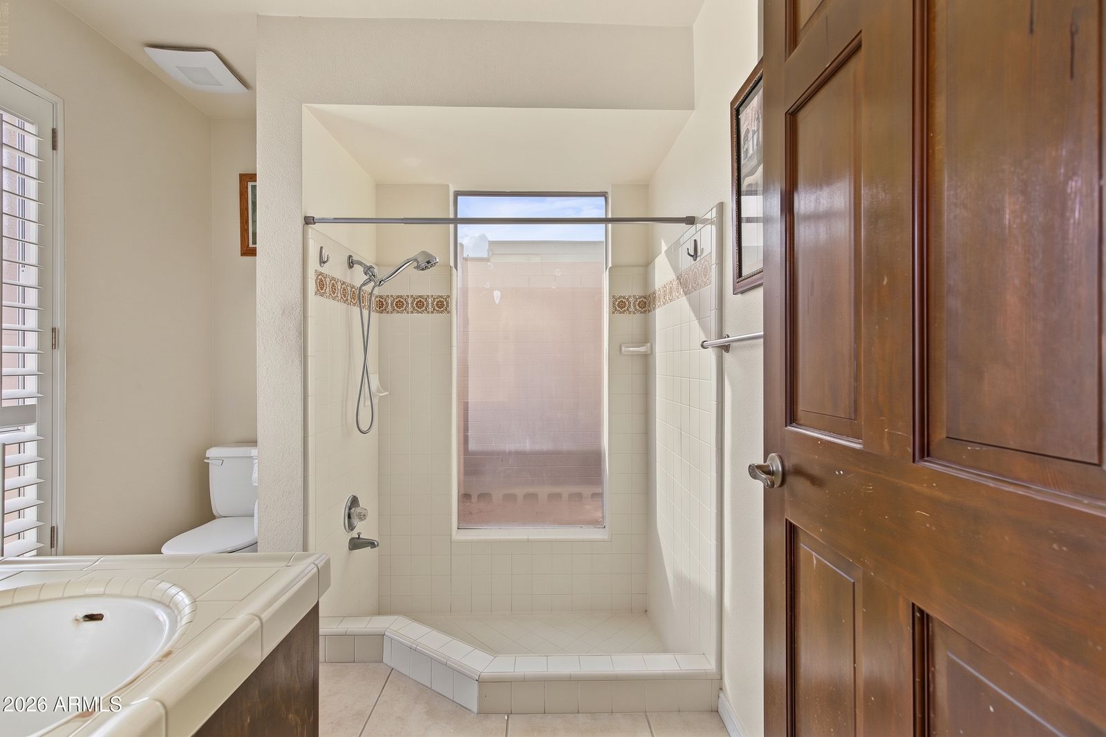 Second bathroom with a tiled shower and window