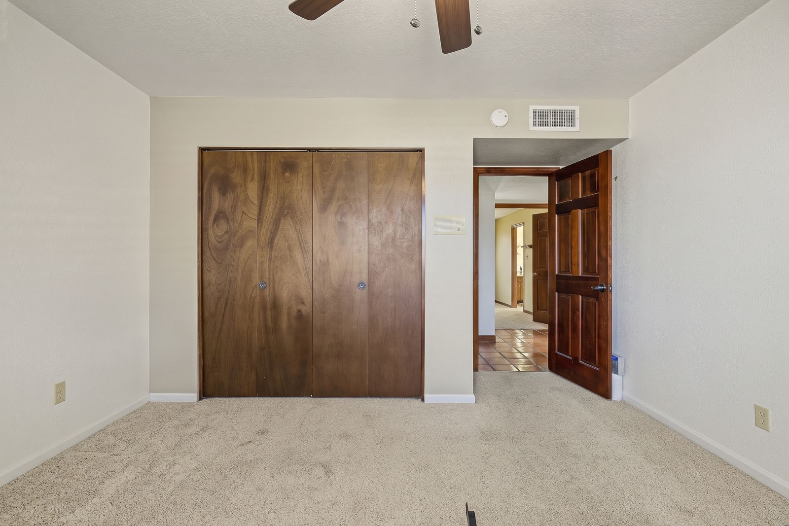 Bedroom with a wood-panel closet