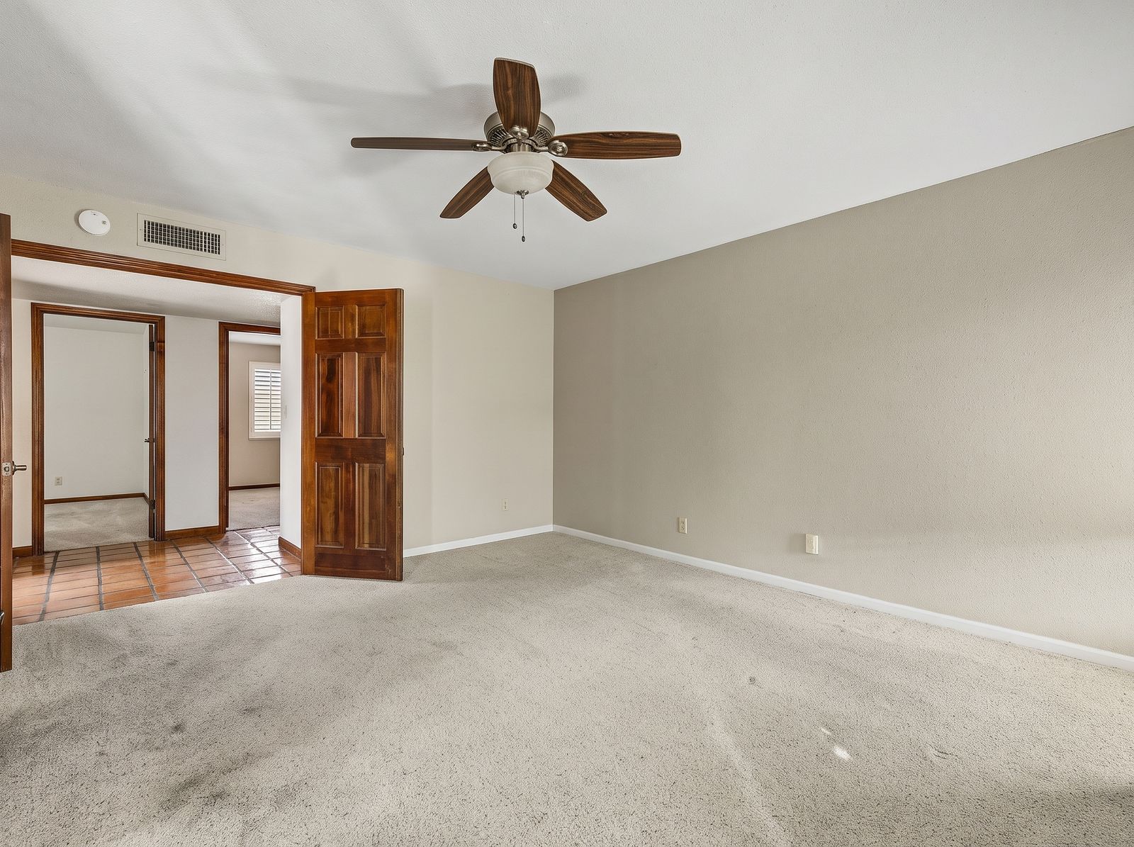 Bedroom with double doors opening to the hallway