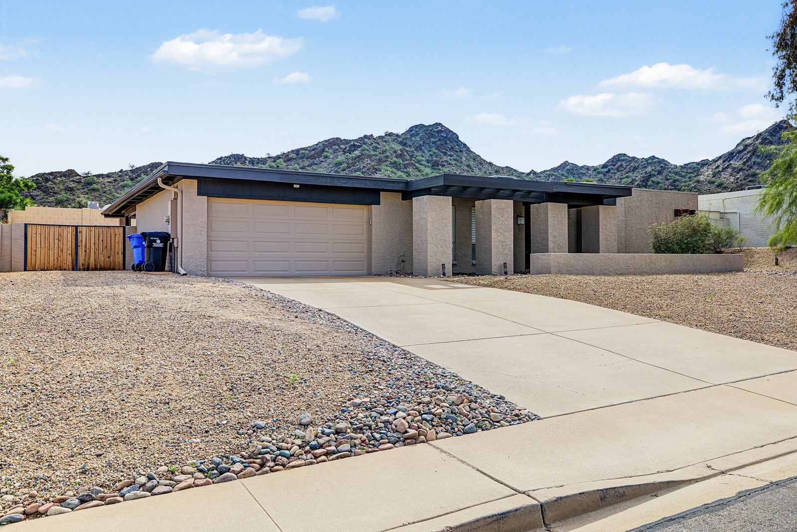 Front of the home with the mountain rising behind it