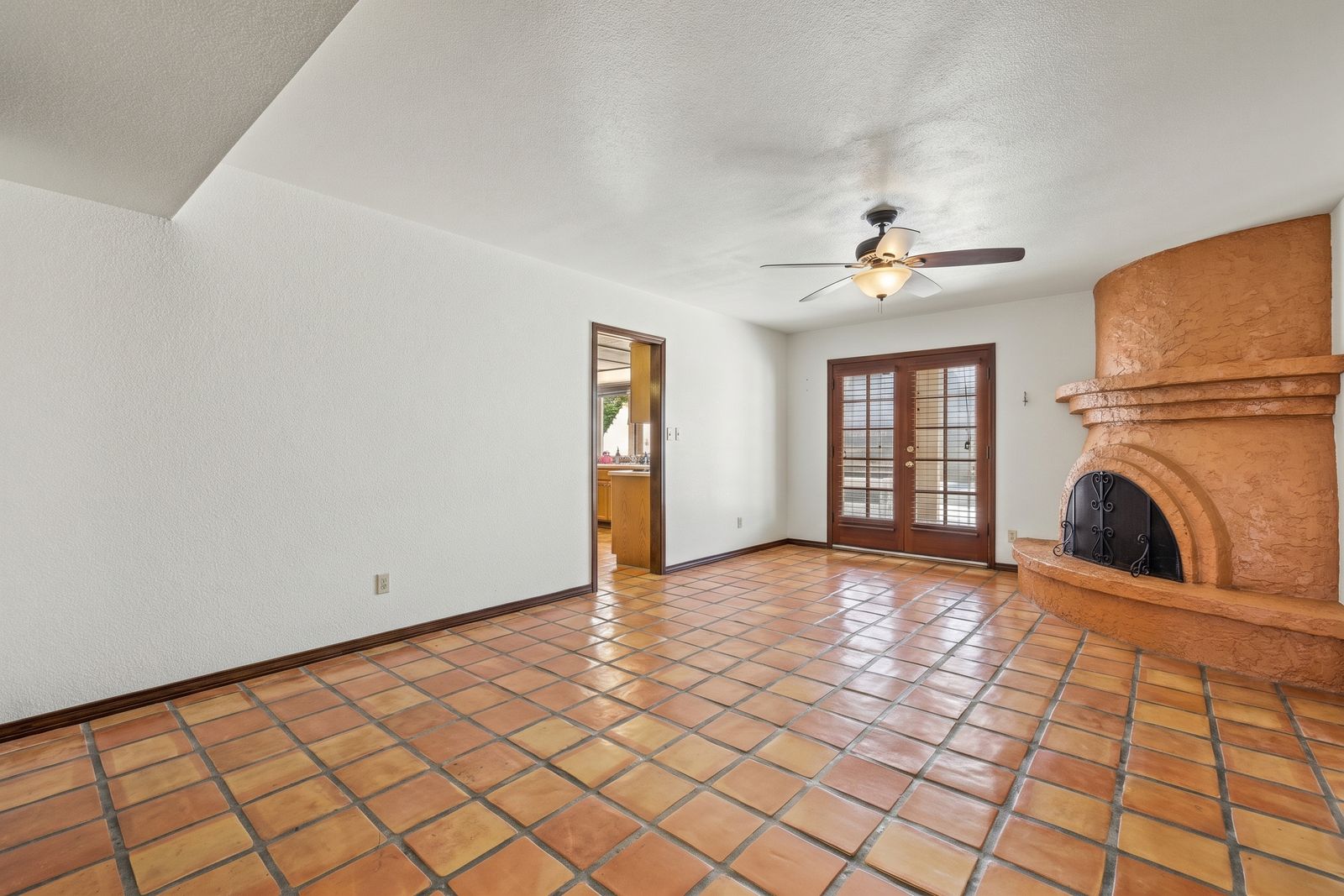 Family room with a beehive fireplace and French doors