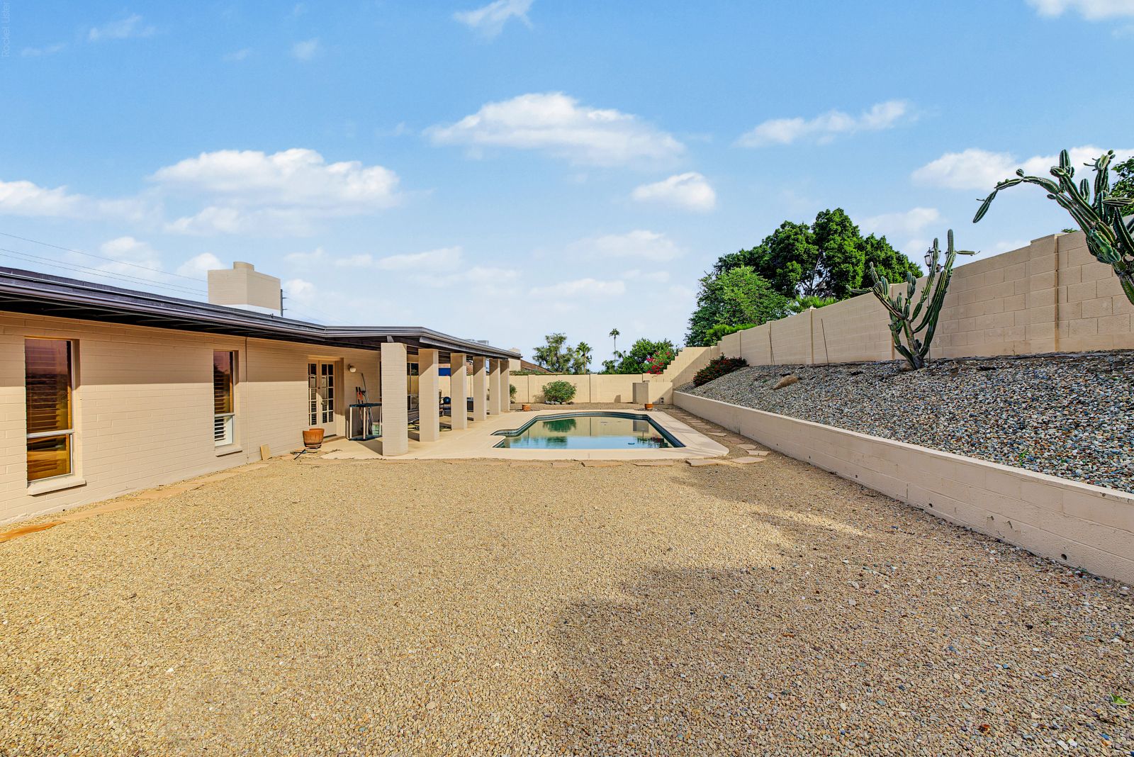 Backyard looking toward the pool and covered patio
